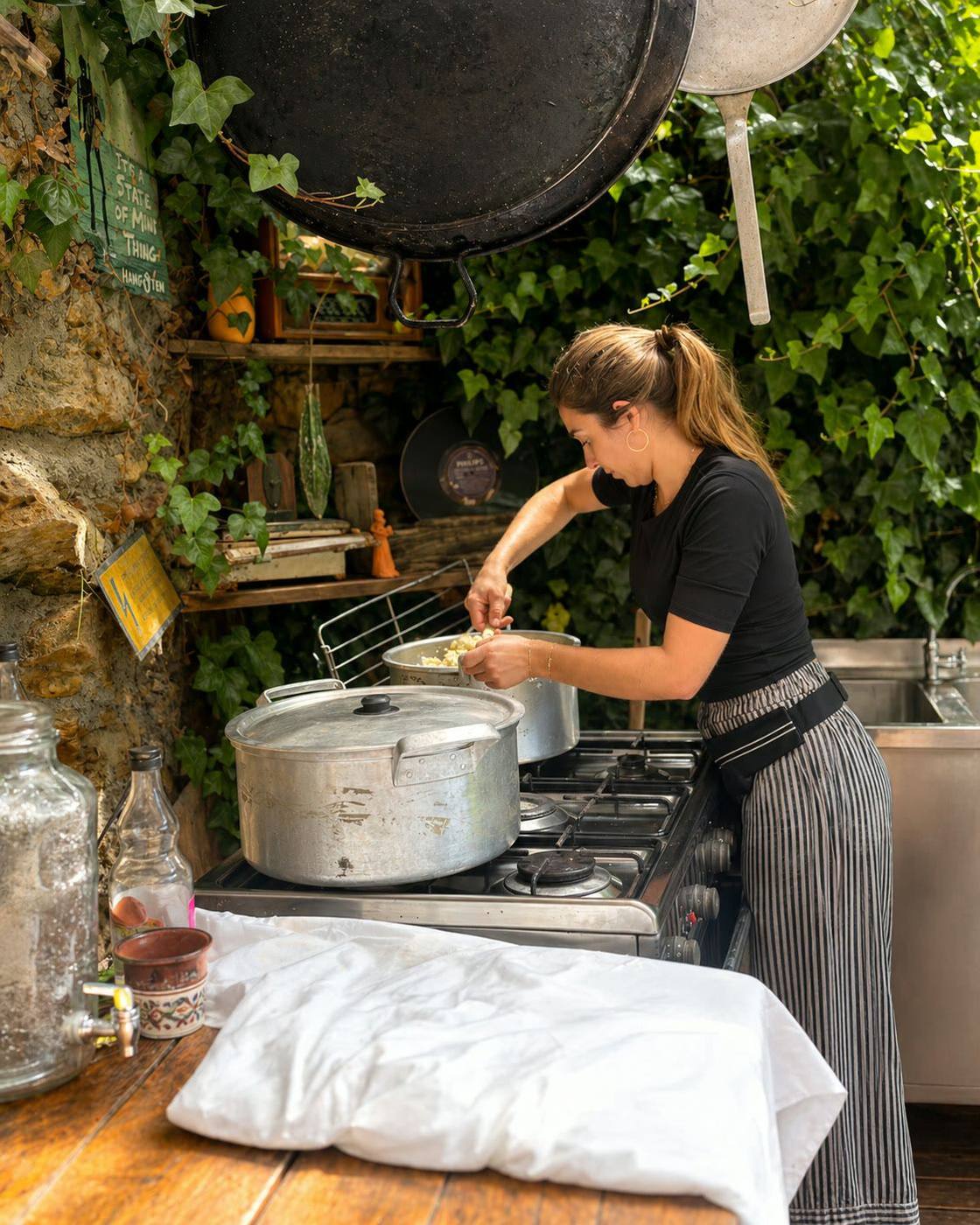 Chef Savoré a cozinhar numa cozinha exterior entre folhagem